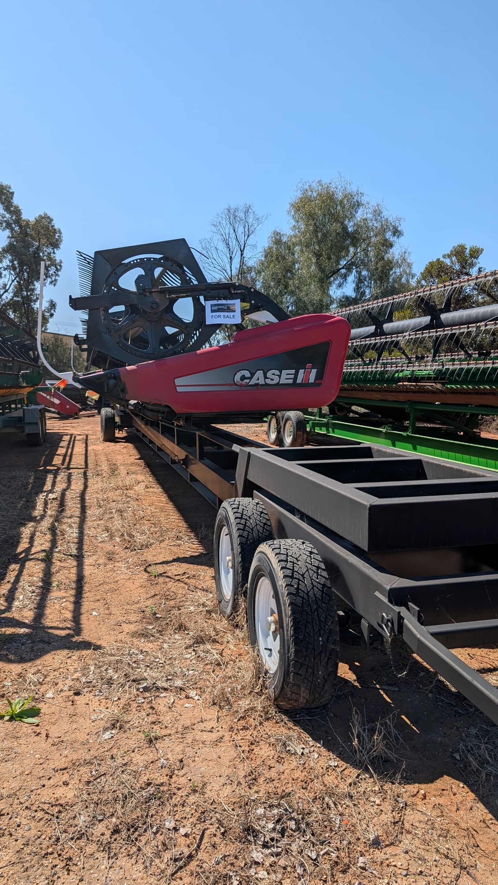 MacDon D60 40ft draper front loaded full length on its header trailer at the HFR yard