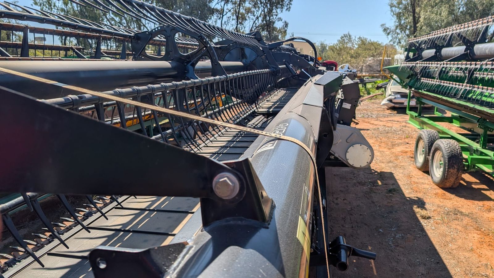 MacDon D60 40ft draper front, close detail of the reel fingers above the cutterbar