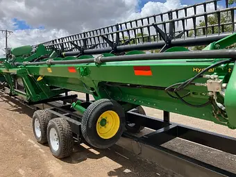 John Deere 740D 40ft flex draper front — full length on comb trailer