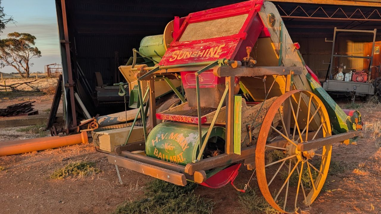 Rear view of the Hugh V. McKay Sunshine harvester at golden hour — Ward family farm, Bulga Road, Swan Hill