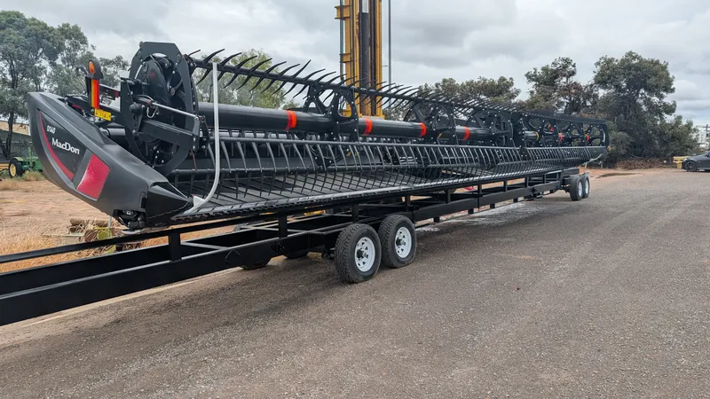 HFR-built comb trailer in the yard at Swan Hill, loaded with a MacDon draper front
